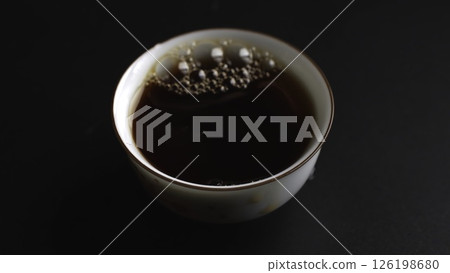 The process of pouring tea into a beautifully crafted traditional cup is quite an art. Media 126198680