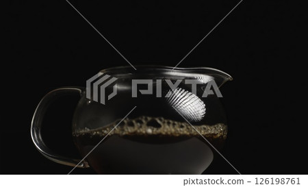 Pouring Tea in an Elegant Glass Teapot for a Refined and Enjoyable Drinking Experience. Media 126198761