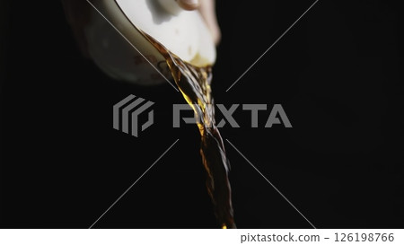 Pouring liquid from a cup creates a beautiful visual, highlighting everyday elegance. Media Pouring liquid from a cup creates a beautiful visual, highlighting everyday elegance. Media 126198766