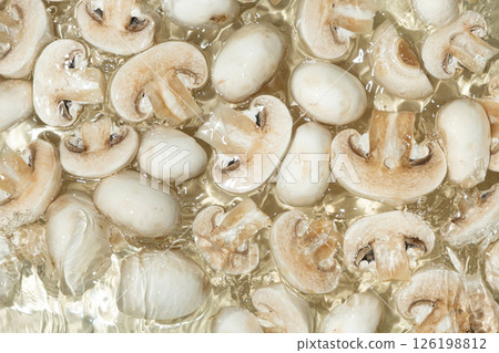 Raw White Mushrooms Champignons Close-Up Splash in a Water Top View Raw White Mushrooms Champignons Close-Up Splash in a Water Top View 126198812
