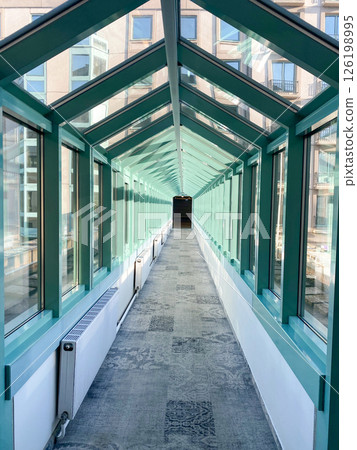 Transparent, glass, suspended corridor connecting the hotel buildings 126198995