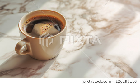 Warm cup of coffee resting on a marble table 126199116