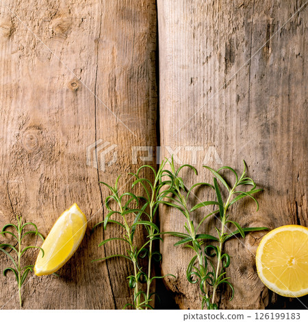 Fresh organic sliced lemon and rosemary branches Fresh organic sliced lemon and rosemary branches 126199183