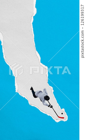 Male hockey player slides with puck through vertical torn paper stripe against blue background. Textured collage style. Male hockey player slides with puck through vertical torn paper stripe against blue background. Textured collage style. 126199317