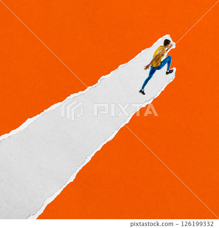 Male runner in yellow top and blue tights runs upward on diagonal torn paper stripe against orange background. Textured scrap collage 126199332
