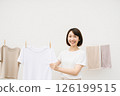 Woman hanging out laundry indoors, top margin 126199515