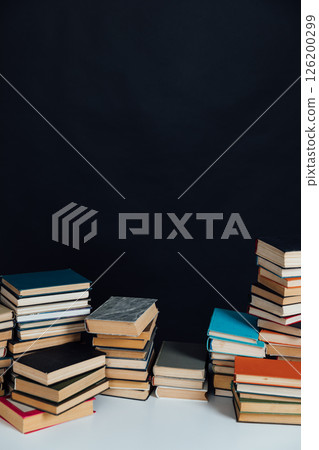 Stacks of educational books for learning on a black background 126200299