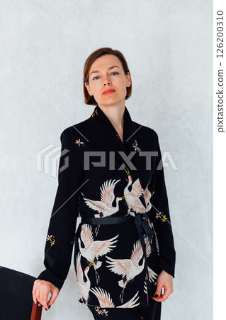 Fashionable woman 40 years old in black suit 126200310