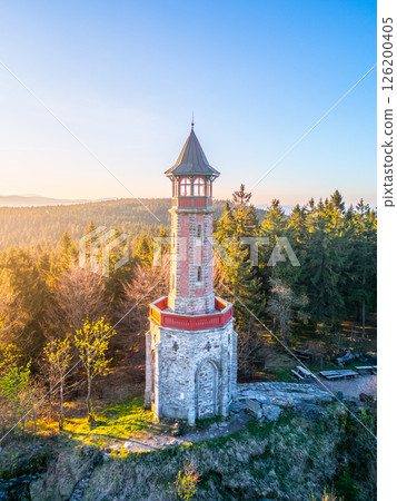 Bright spring morning light illuminates Stepanka Lookout Tower nestled in the Jizera Mountains of Czechia, surrounded by lush trees and vibrant nature. A serene place for visitors to explore. Bright spring morning light illuminates Stepanka Lookout Tower nestled in the Jizera Mountains of Czechia, surrounded by lush trees and vibrant nature. A serene place for visitors to explore. 126200405