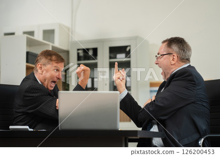 Successful business team, excited mature businessman Keeping up arms and showing positive emotions, happy working in modern office on computer. 126200453