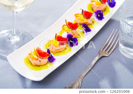 Tasty seafood ceviche from salmon with figs, kiwi and cumquat at plate Tasty seafood ceviche from salmon with figs, kiwi and cumquat at plate 126201006