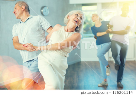 Group of multiethnic mature people dancing social dance 126201114