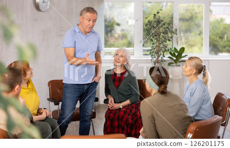 Elderly pensioners listen to an interesting story of an man Elderly pensioners listen to an interesting story of an man 126201175