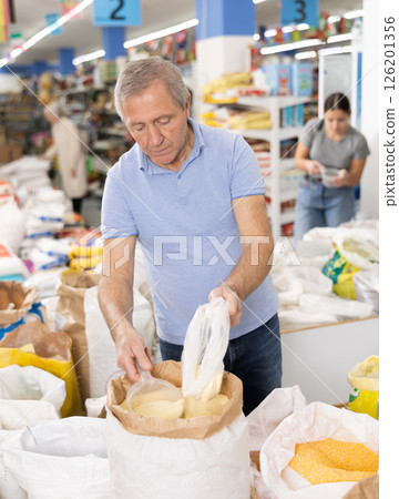 Old man purchaser buying sugar sand in supermarket 126201356