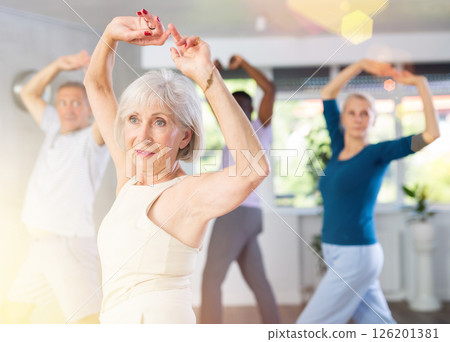 Senior woman dances learn to move energetically to beat of music 126201381