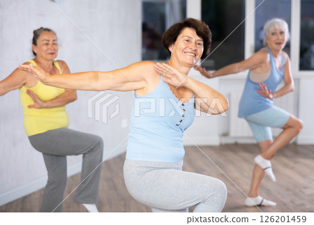 Three elderly women are learning sports Latin American dances in studio class 126201459