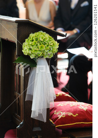 Flower Arrangement on Wooden Pulpit at a Wedding Ceremony Scene 126201541
