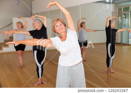 Mature women performing ballet dance in exercise room 126201567