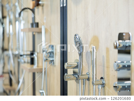 Modern showerheads and bathroom fixtures on display in home improvement store 126201680