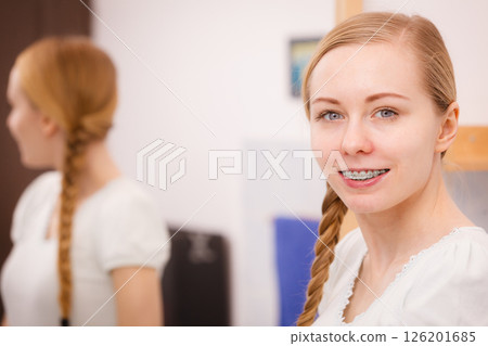 Happy woman reflecting in mirror 126201685
