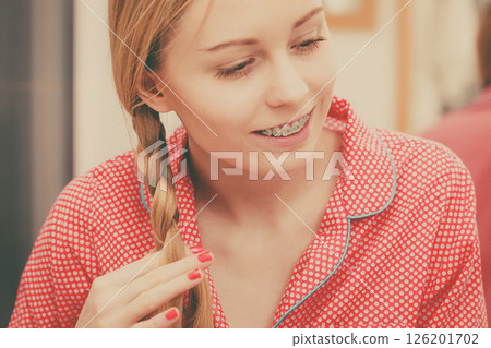 Woman doing braid on blonde hair 126201702