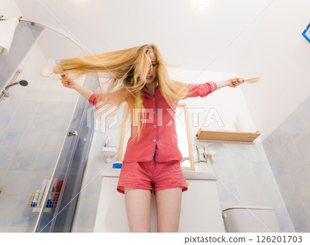 Woman with long windblown blonde hair 126201703
