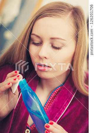 Woman applying tonic on cotton pad 126201706