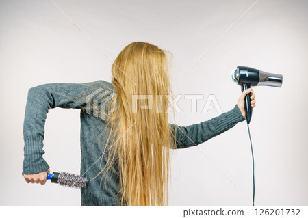 Girl holds hair accessories, styling hair 126201732