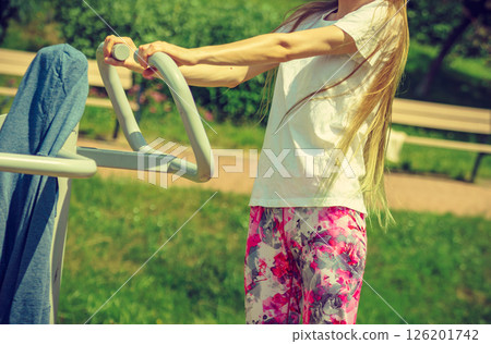 Female doing exercise in outdoor gym 126201742