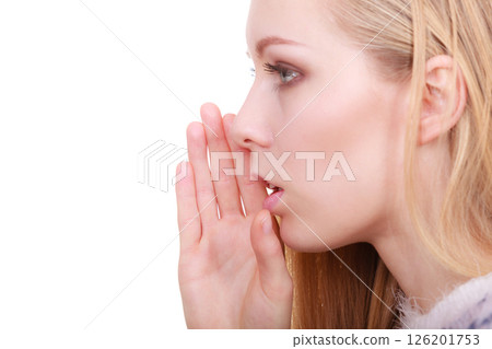 Young blonde woman whispering with hand near mouth 126201753