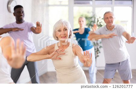 Elderly woman dancing hip hop during group dance class Elderly woman dancing hip hop during group dance class 126201777