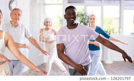 Mature men and women practicing Hip-hop dance in training hall 126201797