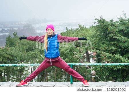 Woman exercising outside during autumn Woman exercising outside during autumn 126201992