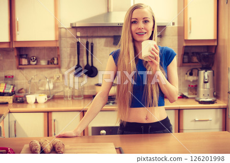 Happy woman holding cup of tea of coffee 126201998