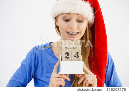Christmas woman holding calendar. 126202376