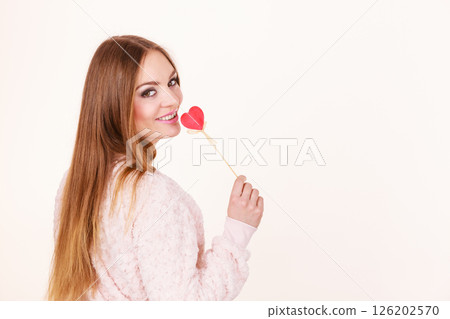 Beautiful woman holding heart shaped hand stick 126202570