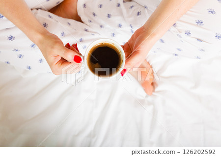 woman on bed with cup of coffee woman on bed with cup of coffee 126202592