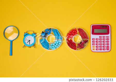 Vibrant collection of colorful school supplies and learning items on a yellow background. 126202833
