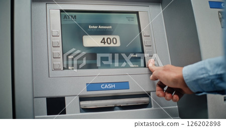 Unrecognizable Man Entering PIN Code on Keypad, Taking US Dollars from ATM Machine Unrecognizable Man Entering PIN Code on Keypad, Taking US Dollars from ATM Machine 126202898