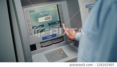 Unrecognizable Man Entering PIN Code on Keypad, Taking US Dollars from ATM Machine 126202905