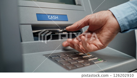 ATM Machine User Pressing Buttons on Display Screen, Taking Money from Cash Dispenser ATM Machine User Pressing Buttons on Display Screen, Taking Money from Cash Dispenser 126202910