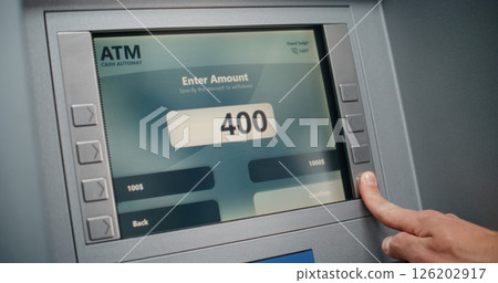 ATM Machine: Unrecognizable Person Entering PIN Code on Keypad, Taking Money ATM Machine: Unrecognizable Person Entering PIN Code on Keypad, Taking Money 126202917