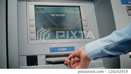 Unrecognizable Man Entering PIN Code on Keypad, Taking US Dollars from ATM Machine 126202919