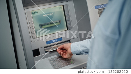 Unrecognizable Man Entering PIN Code on Keypad, Taking US Dollars from ATM Machine 126202920