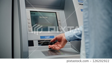 ATM Machine: Unrecognizable Man Entering PIN Code on Keypad, Taking US Dollars 126202922