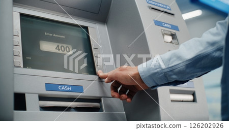 ATM Machine in Airport Terminal: Man Inserting Card, Pressing Buttons on ATM Keypad 126202926