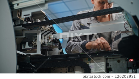 Technician Repairing Internal Components of Automated Teller Machine Technician Repairing Internal Components of Automated Teller Machine 126202951