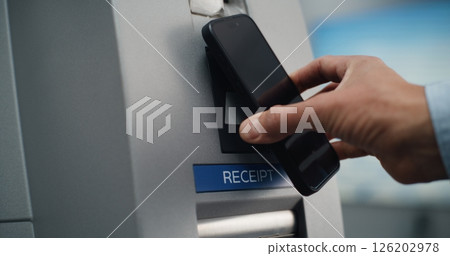 ATM Machine in Airport Terminal: Close Up of Person Putting Smartphone to NFC Reader 126202978