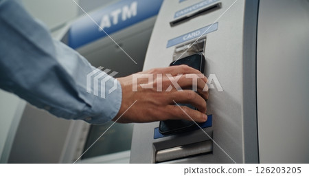 Modern Cash Machine: Unrecognizable Man Putting Smartphone to NFC Reader Modern Cash Machine: Unrecognizable Man Putting Smartphone to NFC Reader 126203205