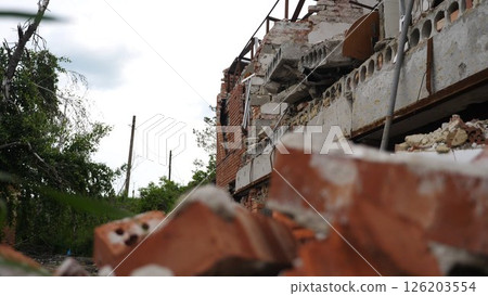View to destroyed residential buildings at Kharkivska oblast. Ruined houses after bomb attacks on ukrainian territory from russia army. Consequences of russian invasion of Ukraine. Slow motion 126203554